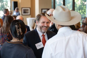 Interim President Jim Davis with Sushil Patel and Priya Shah