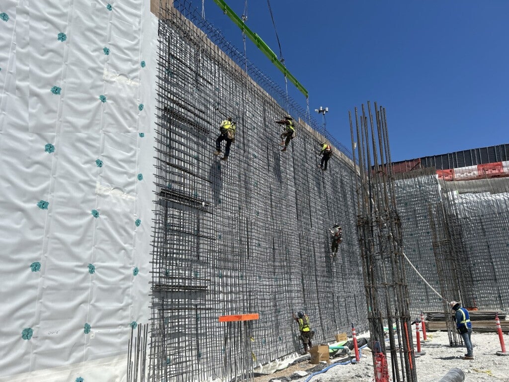 Hoisting bar holding reinforcement bar panel in place while being secured, Aug. 11, 2025